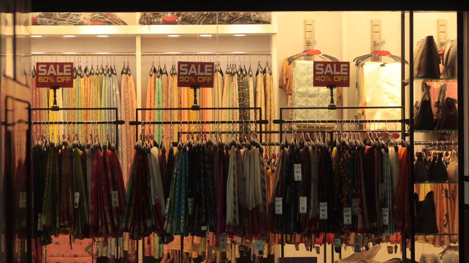 A shop window covered in seasonal sale signs
