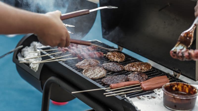 Meat smoking on an outdoor barbecue grill